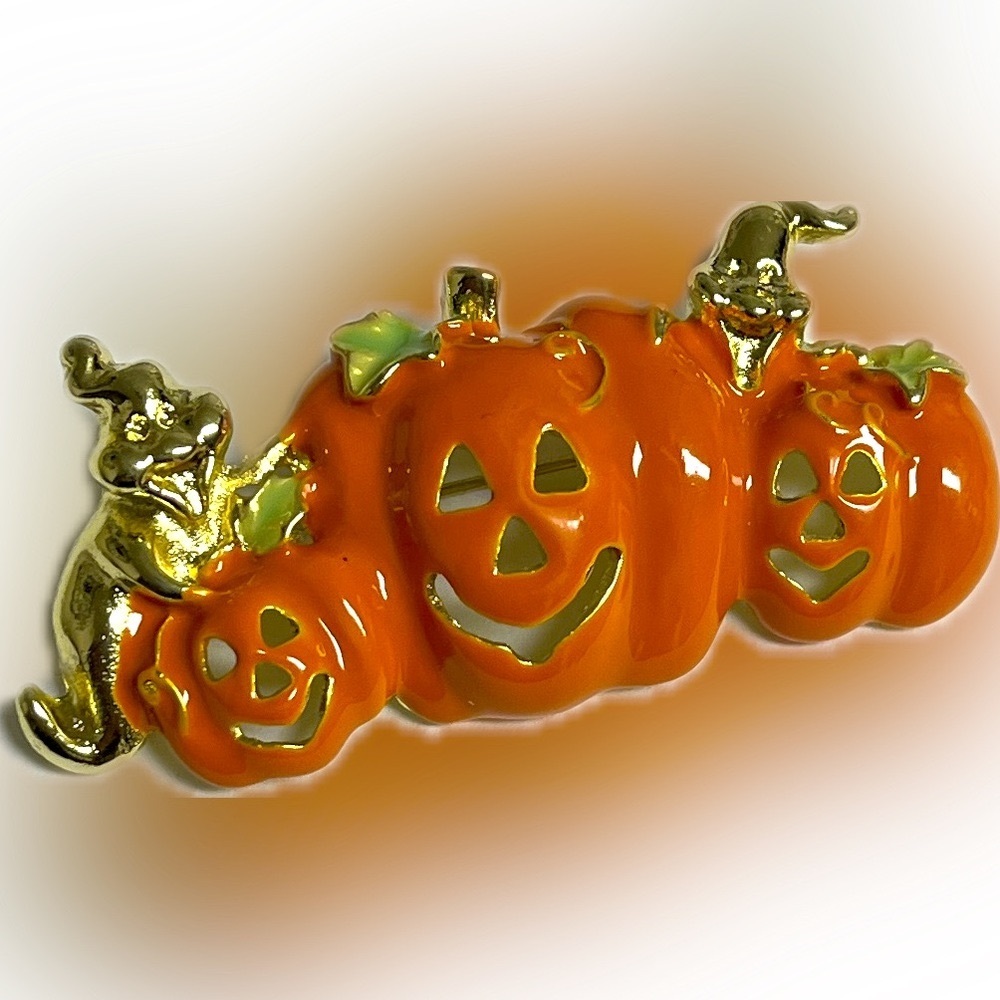Pumpkin brooch with golden ghosts. NIP, Orange and gold, appprox 2”x1”.